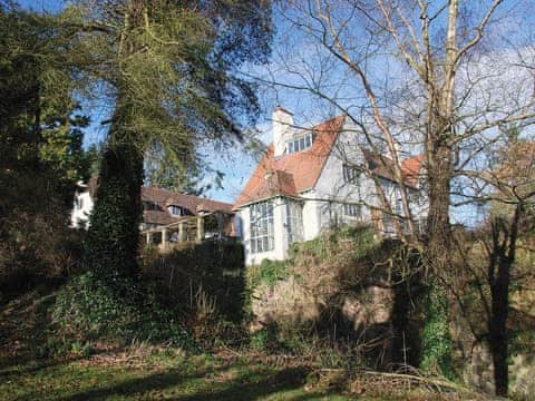 The impressive Arts and Crafts house viewed from the drive | Sandford Country Cottages