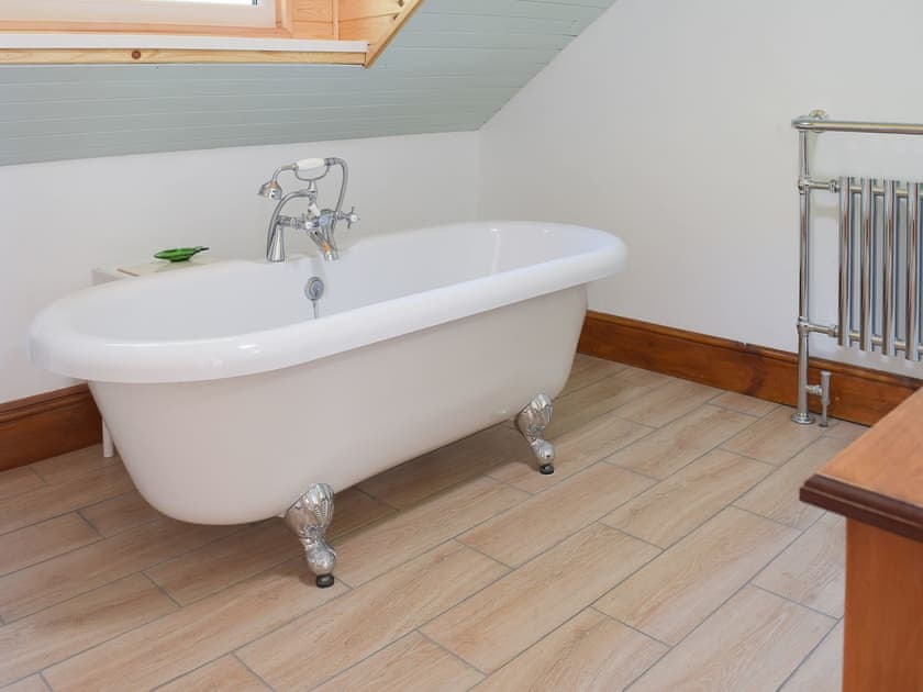 Lovely bathroom with stand alone roll top bath | Woodlands, Laugharne, near Pendine