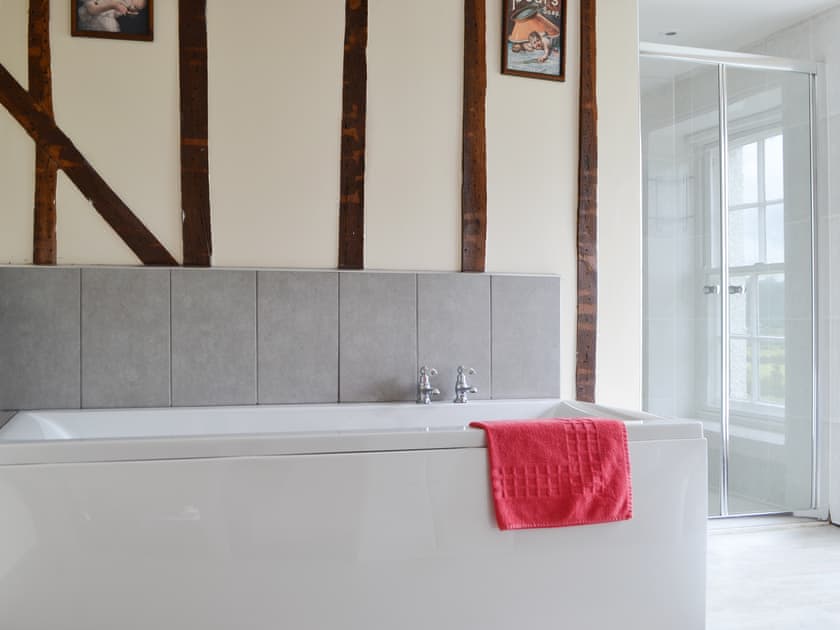 Light and airy bathroom with bath and separate shower cubicle | Little Brampton Farmhouse, Clunbury, near Ludlow