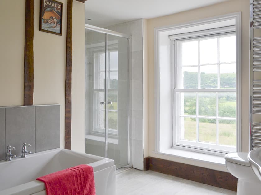 Light and airy bathroom with bath and separate shower cubicle | Little Brampton Farmhouse, Clunbury, near Ludlow