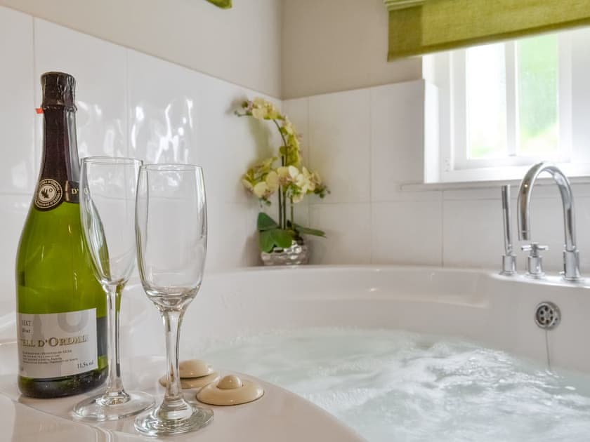 Jacuzzi bath within the stylish bathroom | The Dove Cot & Annexe, The Dove Cot - The Dove C, Clappersgate, near Ambleside