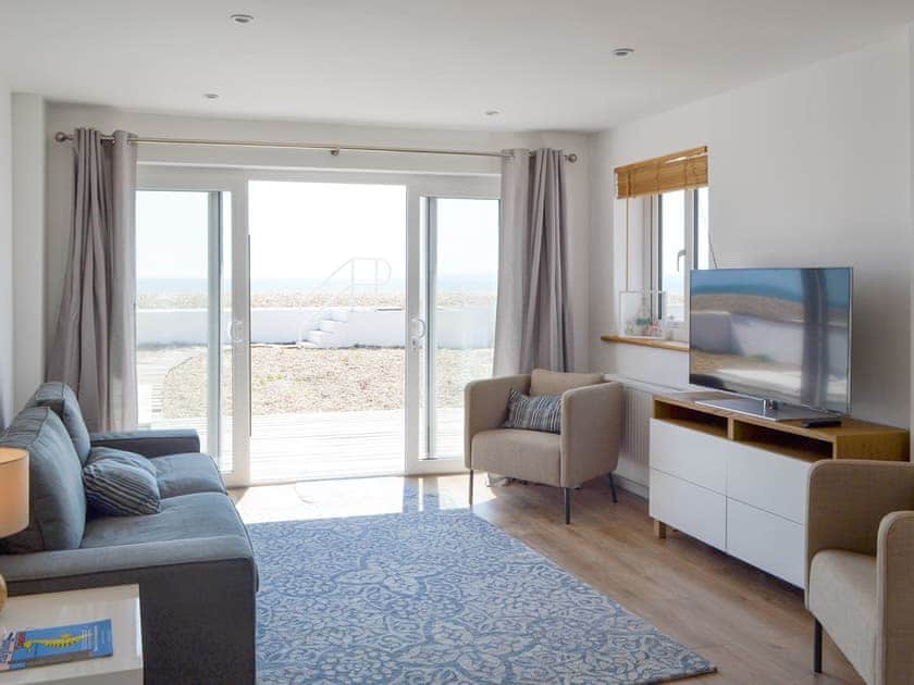 Stylish living area with patio doors to decked patio area | Salty Lodge, Hayling Island