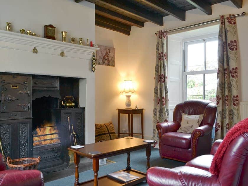 Cosy living room with open fire | Gilmore House, Alston