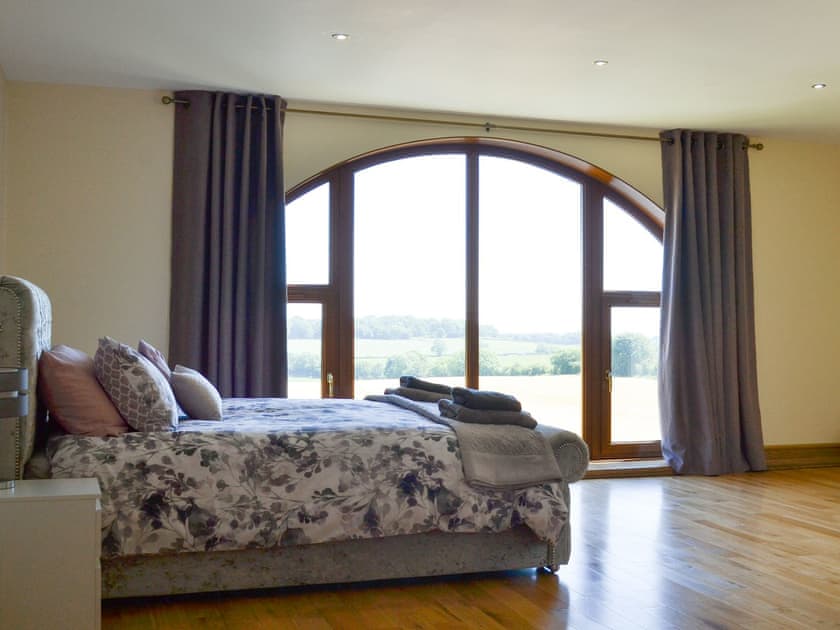 fabulous master bedroom with kingsize bed, cot, large picture window, dressing room and large en-suite bathroom | Applegarth House, Howlish, near Bishop Auckland