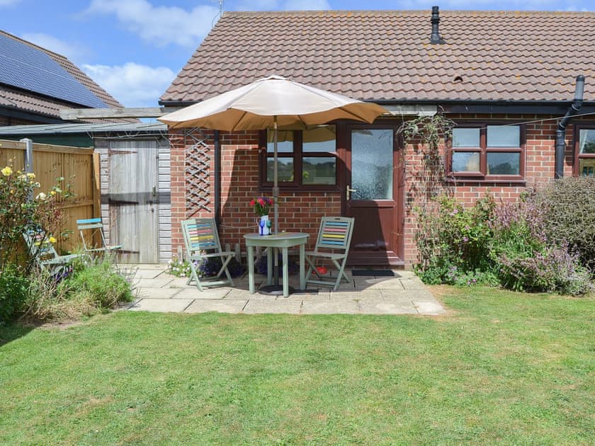 Lawned garden with shady patio area | Tamarisk, Walcott