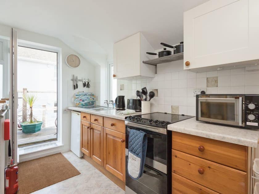 Well equipped kitchen with door to terrace | College View Upper, Kingswear
