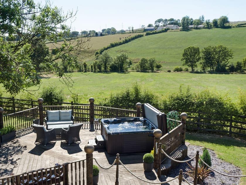 Inviting patio with sitting-out area and hot tub | Tennox Parlour - Tennox Farm, Kilbirnie