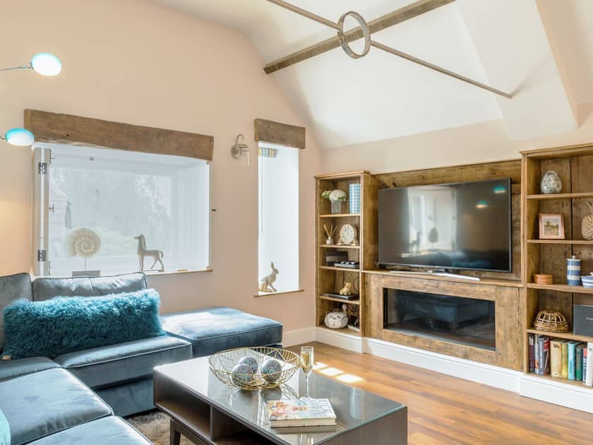 Living area with large screen tv | Stone Barn - Vicarage Road Holiday Cottages, Minehead