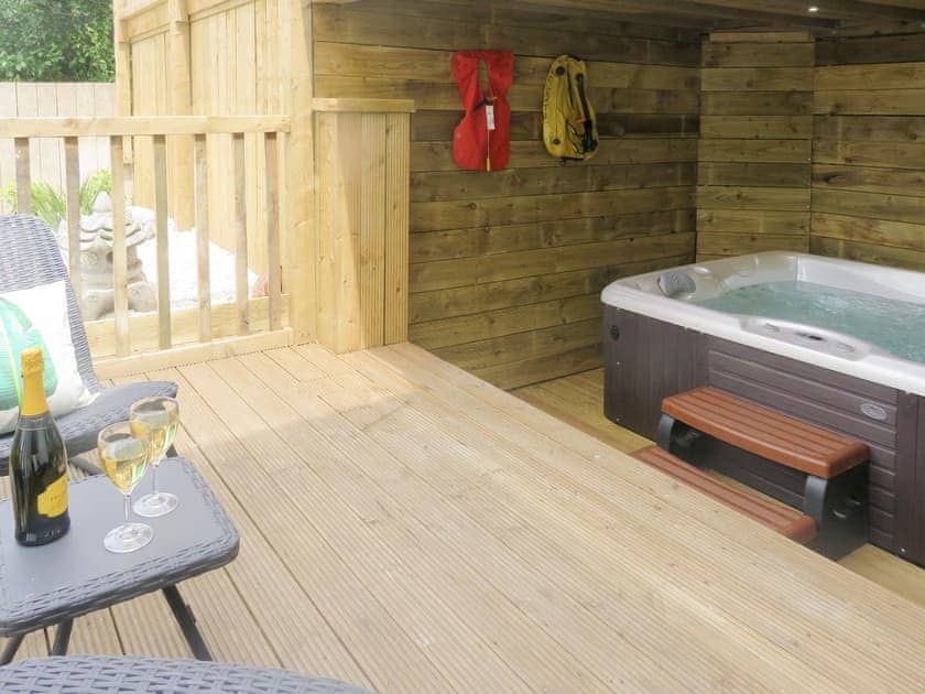 Decked area with covered area for the hot tub | Esk Cottage - Cyana Cottages, Whitby