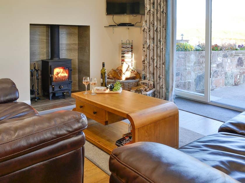 Lovely and welcoming living area with patio doors to the courtyard | Liftingstane Dairy Cottage - Liftingstane, Closeburn, near Thornhill