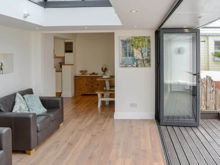 Light and airy sun room with bi-fold doors into the garden | Broadland Hideaway, Martham, near Great Yarmouth