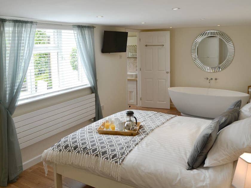 Attractive master bedroom with free standing bath | Broadland Hideaway, Martham, near Great Yarmouth
