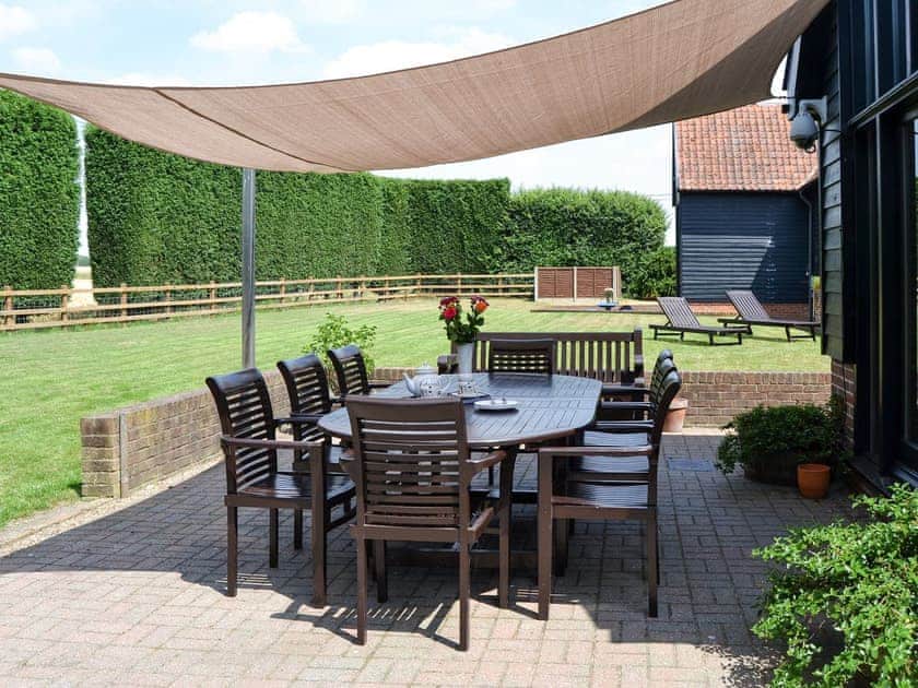Outdoor seating area overlooking the garden | Clamp Farm Barn, Creeting St Peter, near Stowmarket