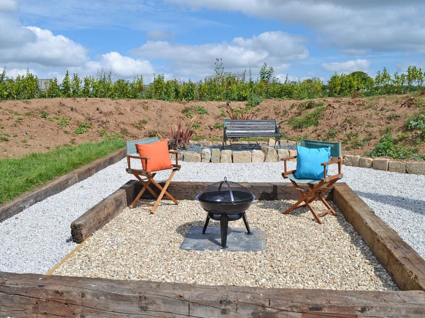 Inviting sitting-out-area with fire pit | The Wool Shed, Gorran, near St Austell