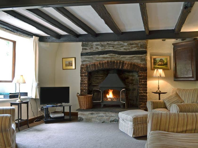 Characterful living room with beams and wood-burning stove | Oaks Farm Cottage, Ambleside