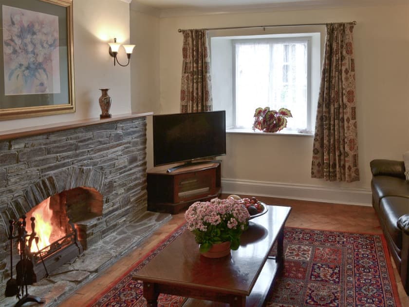 Living room with open fire | The Farmhouse - Lanwithan Cottages, Lostwithiel