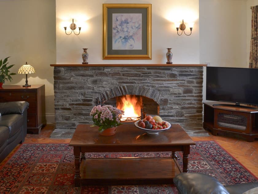 Cosy living room with open fire | The Farmhouse - Lanwithan Cottages, Lostwithiel