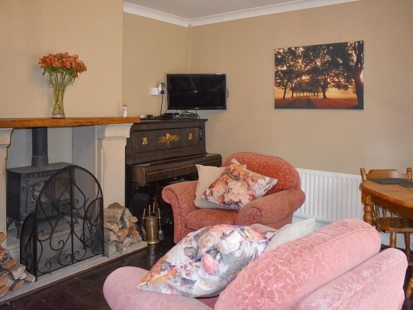 Warming wood burner within the dining room | Oakdene Lodge, Wimborne