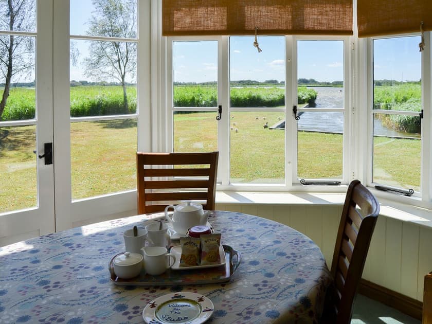 Dining area overlooking the lawned garden | The Studio, Hickling
