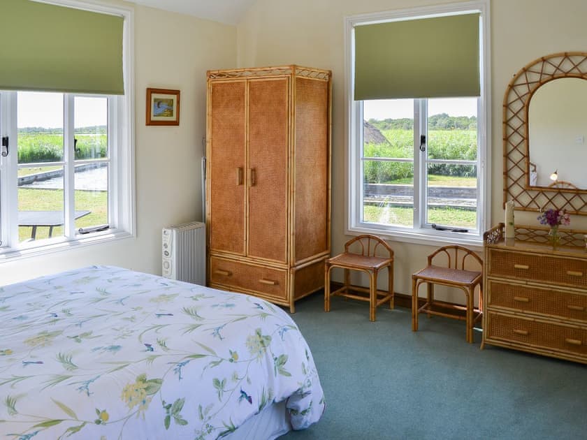 Relaxing bedroom with dual aspect views | The Studio, Hickling