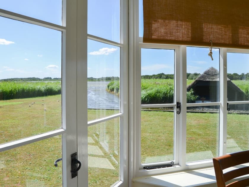 Sunny conservatory with double doors to the waterside garden | The Studio, Hickling