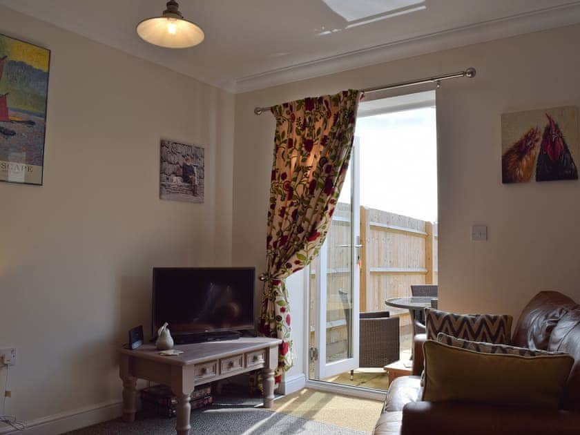 Living room with patio doors leading to the garden | Cosy Cotswolds Townhouse, Shipston-on-Stour