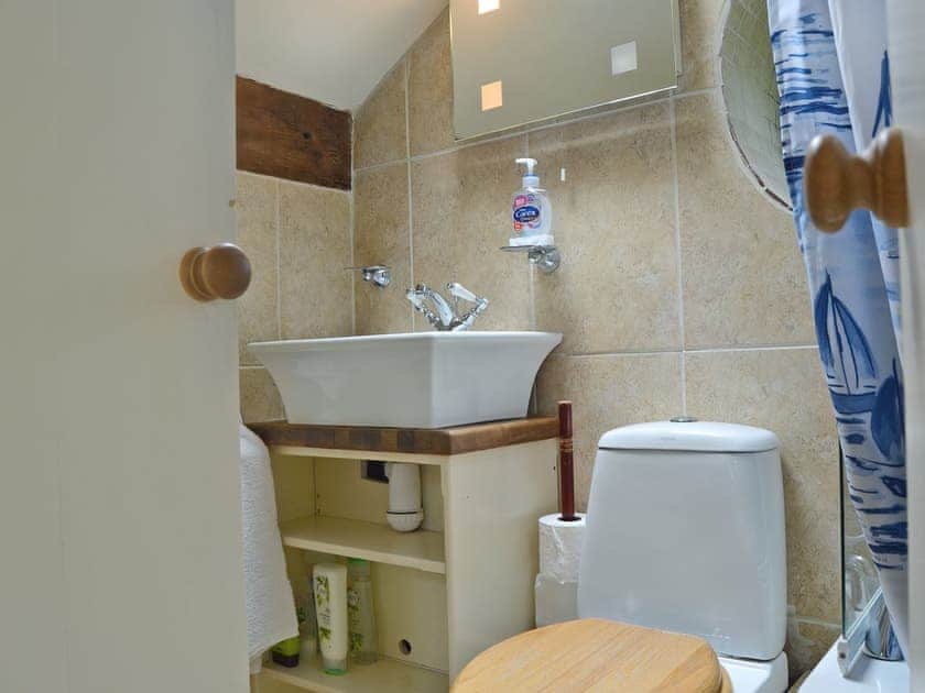 En-suite bathroom with shower over bath | The Pigsty Cottage, Oswestry