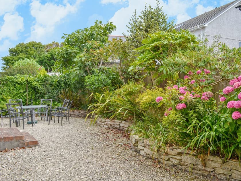 Patio garden with sitting out area | Poppy Cottage, Crantock, near Newquay