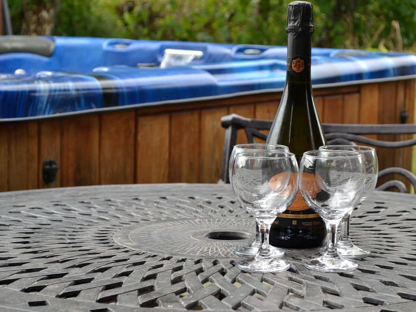 Relax and enjoy a drink by the hot tub | Edw Lodge - Boatside, Aberedw, near Builth Wells