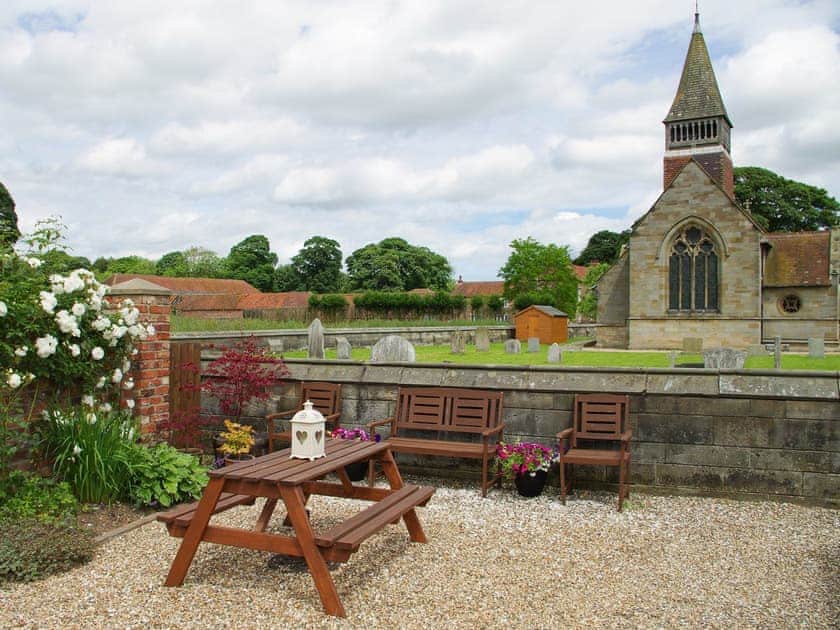 Gravelled patio area with outdoor furniture | The Old Forge, West Lutton near Malton