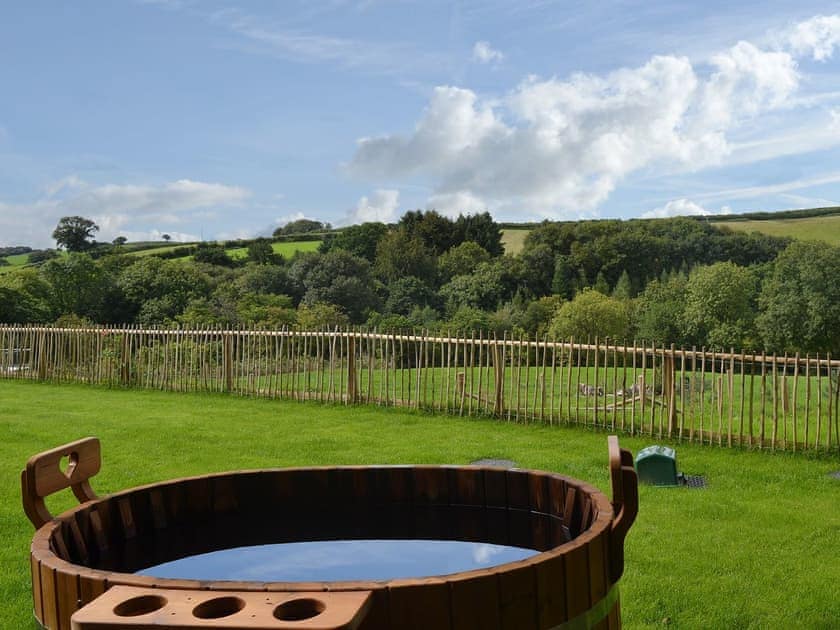 Admire the breathtaking view from the wood-fired hot tub | The Cart Linhay, Meshaw, near South Molton