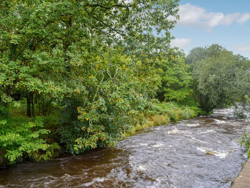 River (unfenced) running past the garden | Tryfan - The Woollen Mill, Penygroes, near Caernarfon