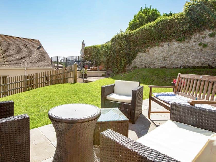 The large lawned rear garden with an elevated sitting out area | Innisfree, Salcombe