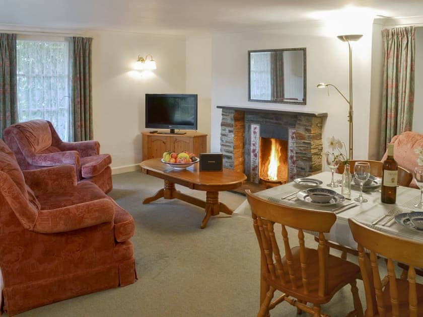 Living/ dining room with xosy open fire | Granny’s Cottage - Lanwithan Cottages, Lostwithiel