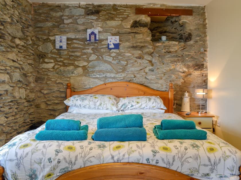 Exposed stone feature walls in double bedroom | Penteryfn, near Holyhead, Isle of Anglesey