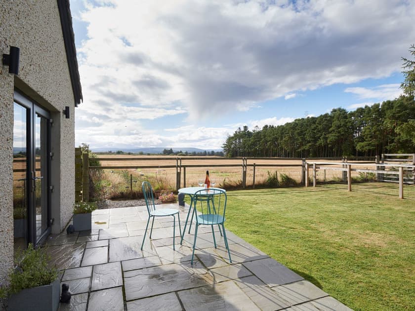 Paved patio and lawned garden | Barn Owl Cottage, Newton, near Tain
