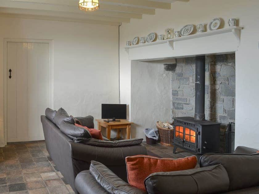 Living room with a cosy wood burner | Penrhyn Mawr, Aberdaron