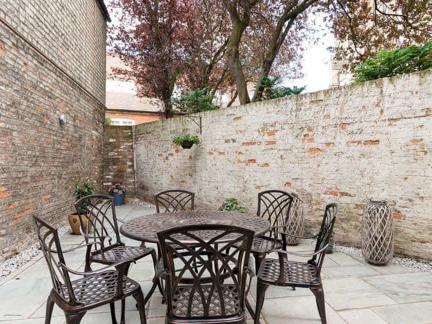 Enclosed courtyard with sitting-out area and garden furniture | Beverley Minster House, Beverley