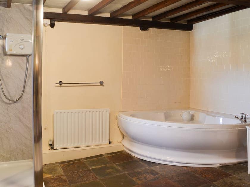 Soacious bathroom with corner bath and shower cubicle | Birkerthwaite Barn - Birkerthwaite Cottages, Eskdale