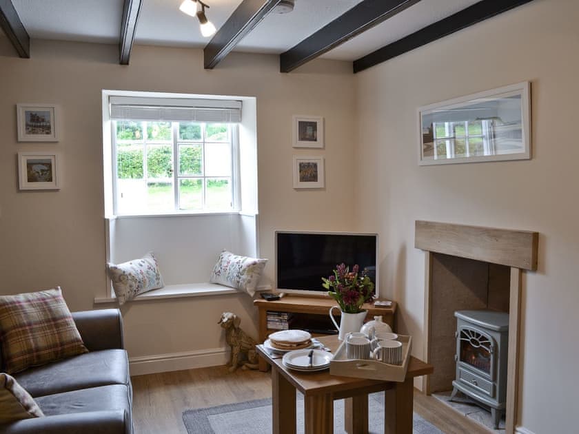 Cosy living room with wood beam ceiling | Derwent Cottage, Wrench Green, near Scarborough