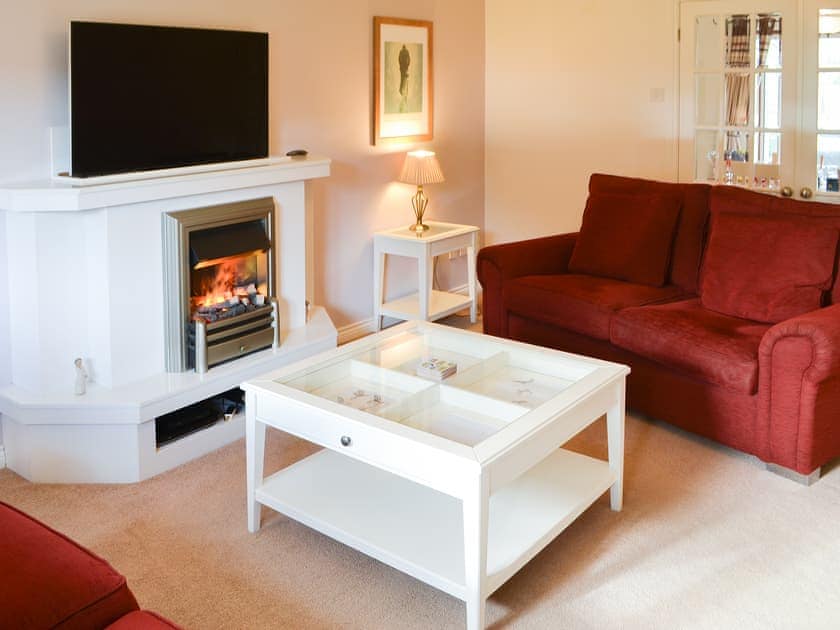 Stylish living area with double doors to dining room | Hawthorne House, Amble, near Warkworth