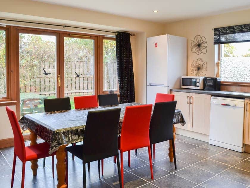 Large kitchen/diner with doors to the garden | Croftside House - Allt Mor Cottages, Aviemore