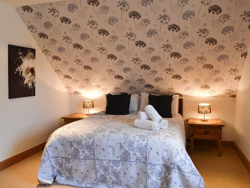 Roomy double bedroom with sloping ceiling | Croftside House - Allt Mor Cottages, Aviemore