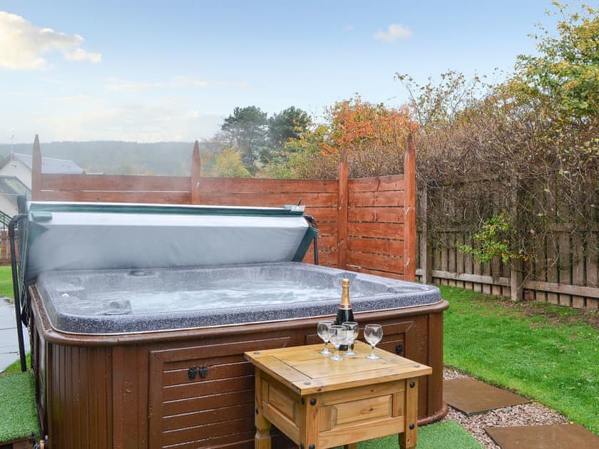 Relax in the lovely hot tub | Cairn View, Croftside House - Allt Mor Cottages, Aviemore