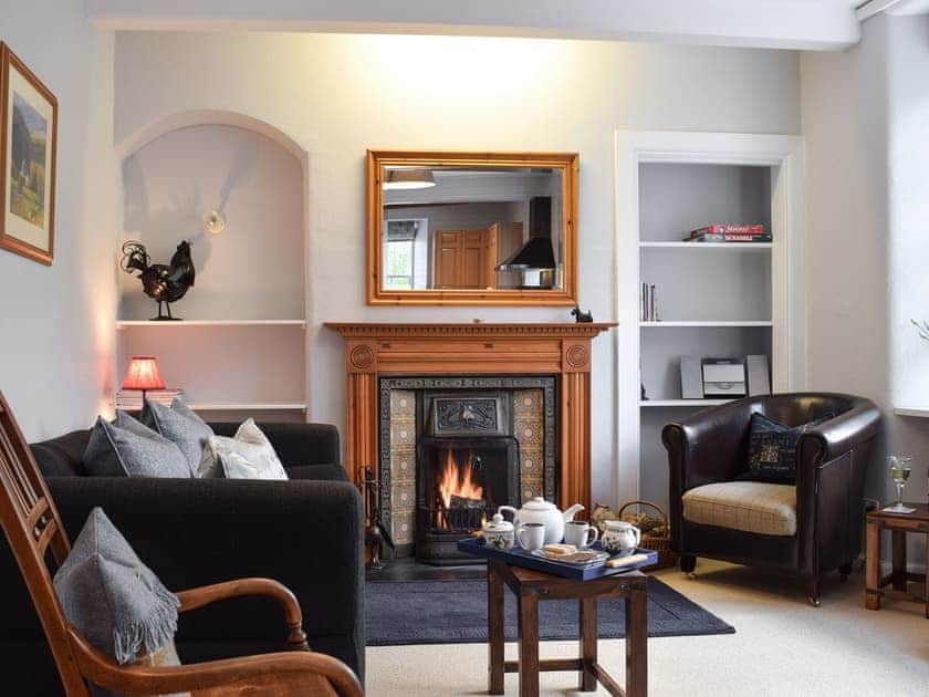 Cosy living room with open fire | Ardchoille Cottage, Fortingall, near Aberfeldy