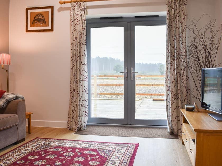 Comfortable living space with patio doors to the decked area | Sid’s Place, Ringwood