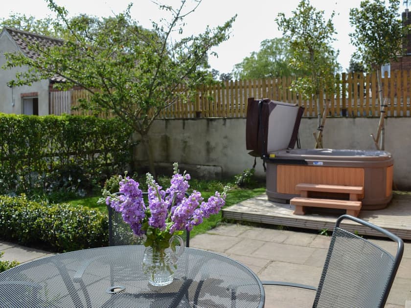 Paved patio with furniture and hot tub | The Forge - Mackinder Farms, Brayton, Selby