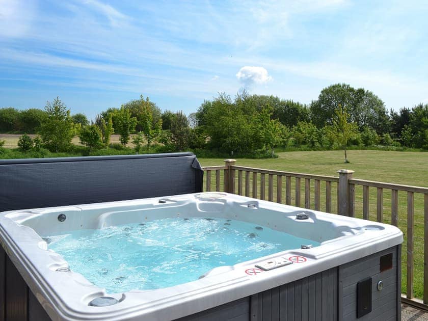 Luxurious hot tub on decked terrace | Kingfisher Lodge - Mackinder Farms, Brayton, Selby
