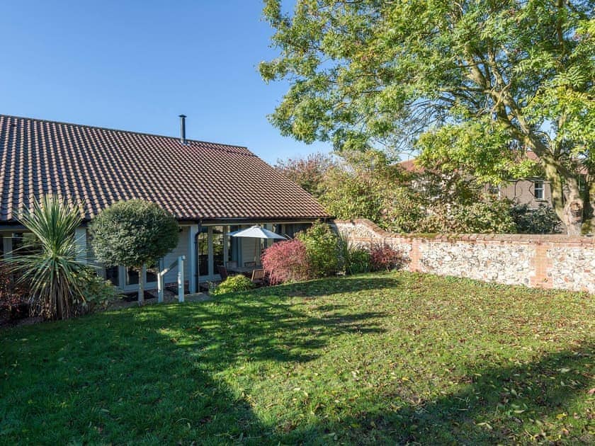 Lawned garden with sitting-out area | The Strawhouse - Manor Mews, Tattersett, near Fakenham