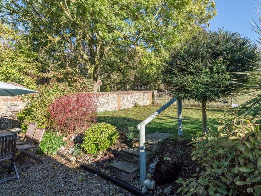 Lawned garden with sitting-out area | The Strawhouse - Manor Mews, Tattersett, near Fakenham